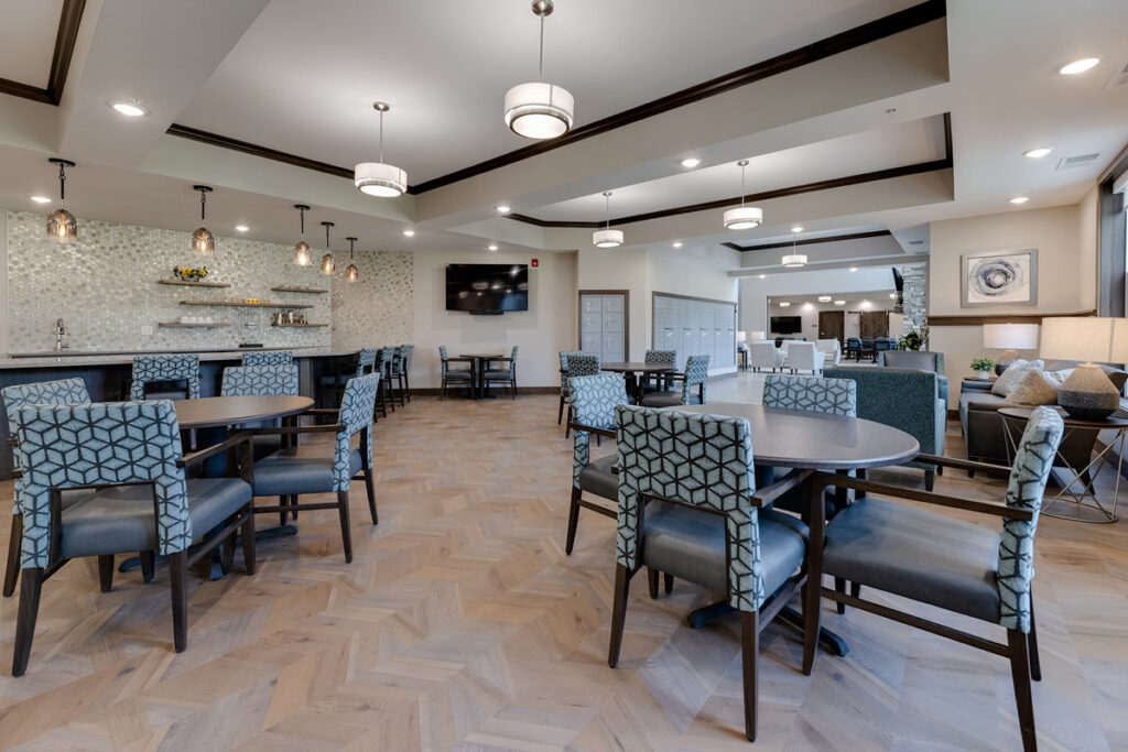 Bistro seating area at Meadowview of Johnston featuring café-style tables, comfortable seating, and a beverage bar for social gatherings.