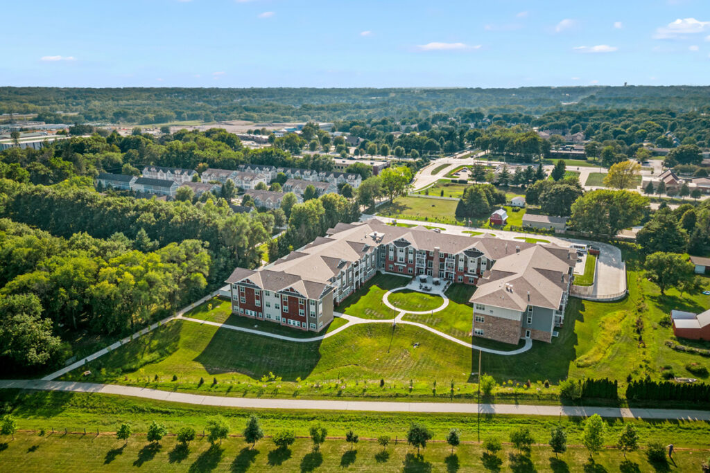 Aerial overview of Meadowview of Johnston senior living community featuring landscaped grounds, walking paths, and a central courtyard.