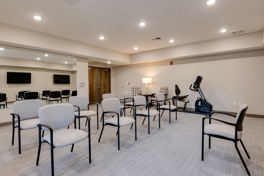 Fitness center at Meadowview of Johnston featuring exercise equipment and space for resident wellness and group fitness activities.