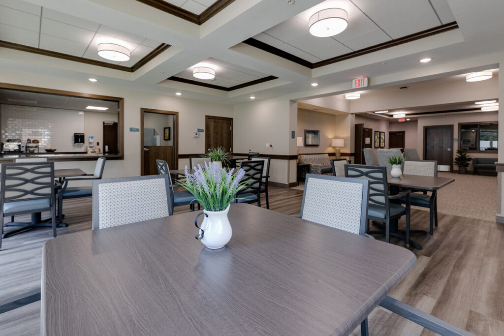 Memory care dining and gathering area at Meadowview of Johnston featuring open seating, natural light, and thoughtfully designed common spaces for residents with memory loss.