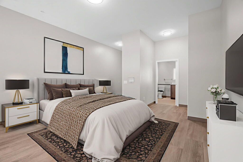 Spacious memory care suite at Meadowview of Johnston featuring a private bedroom, accessible bathroom, and comfortable home-like furnishings designed for residents with memory loss.