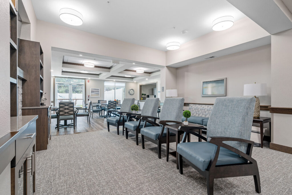 Memory care common area at Meadowview of Johnston featuring comfortable seating, open gathering spaces, and a welcoming home-like environment for residents with memory loss.