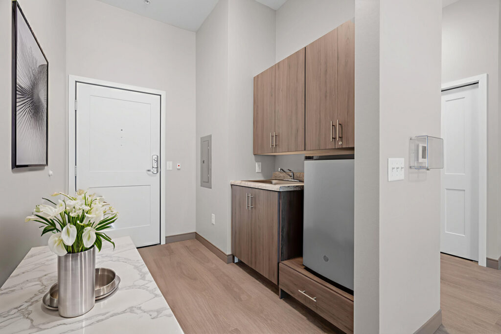 Memory care suite at Meadowview of Johnston featuring a private kitchenette, accessible layout, and home-like design for residents with memory loss.