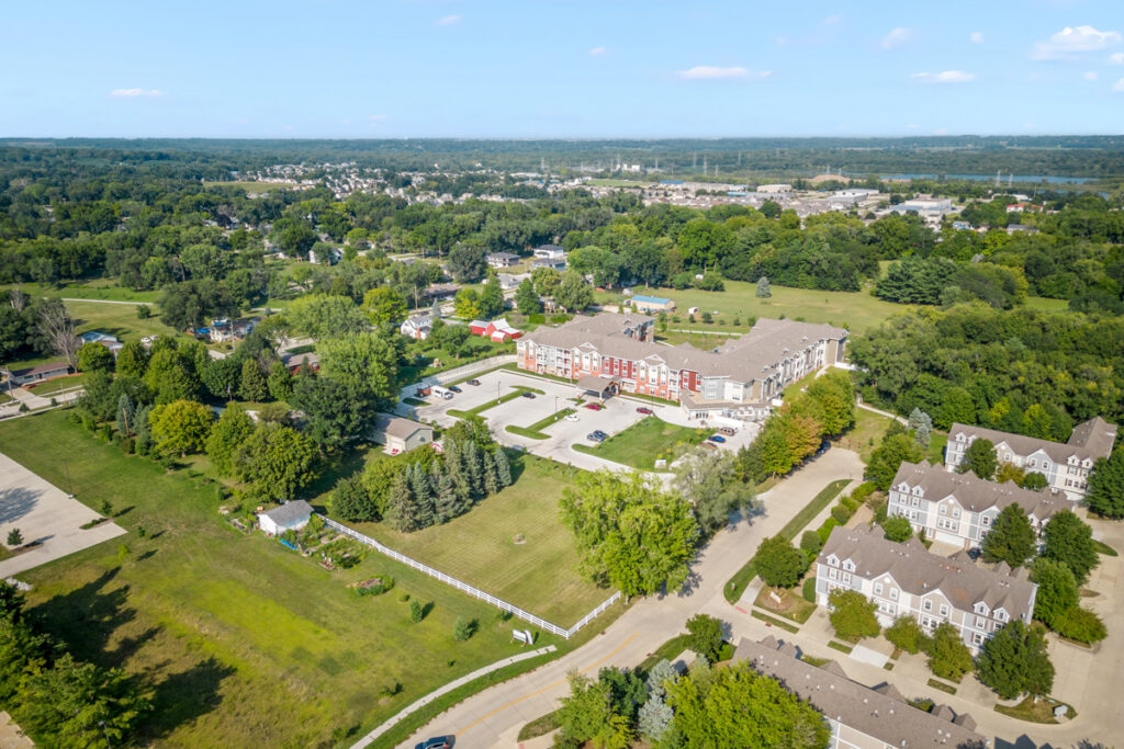 Aerial view of Meadowview of Johnston senior living community and the surrounding Johnston, Iowa neighborhood with nearby green space and residential areas.