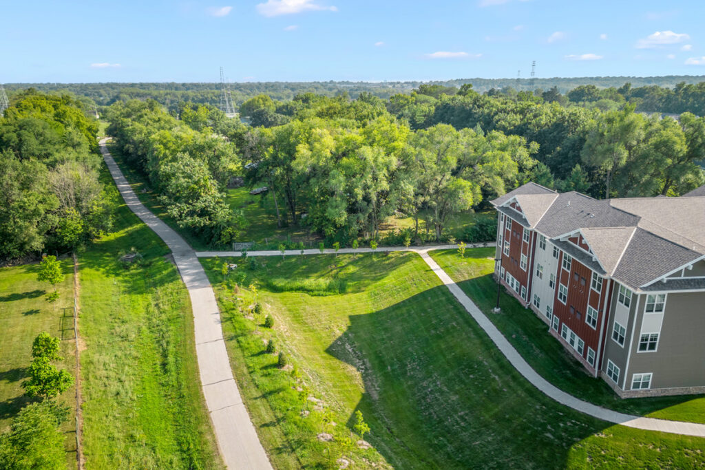 Walking path and green space next to Meadowview of Johnston senior living community in Johnston, Iowa.