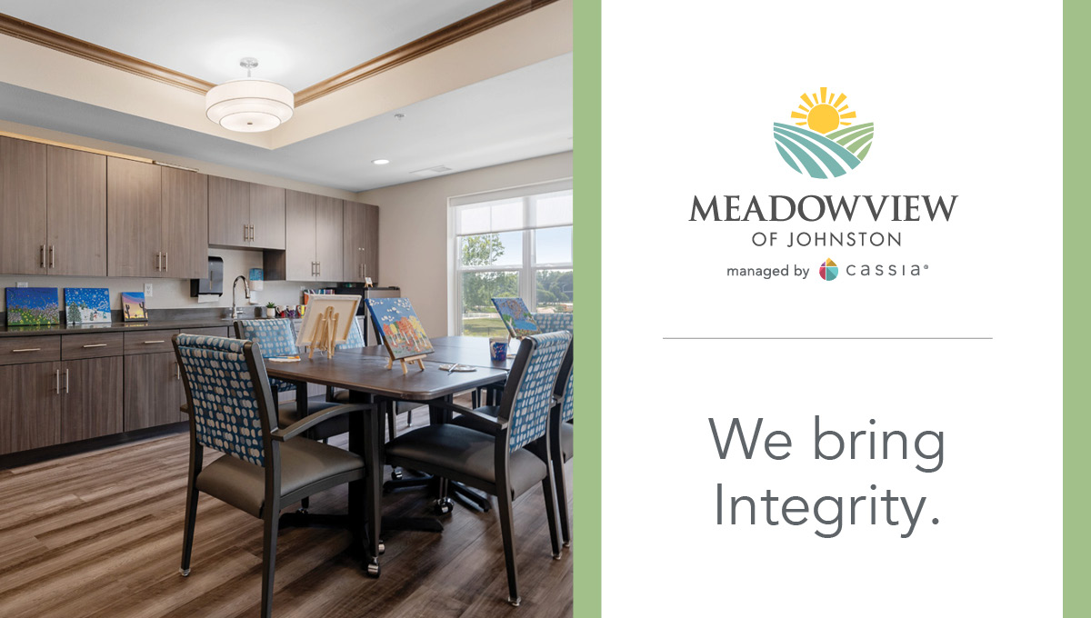 Meadowview of Johnston activity room with painting easels, comfortable seating, and community artwork.